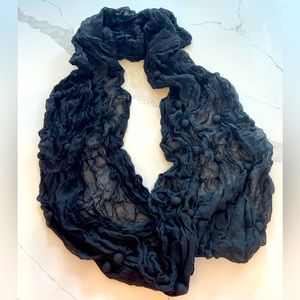 Beautiful infinity scarf with ruching and pom pom details.